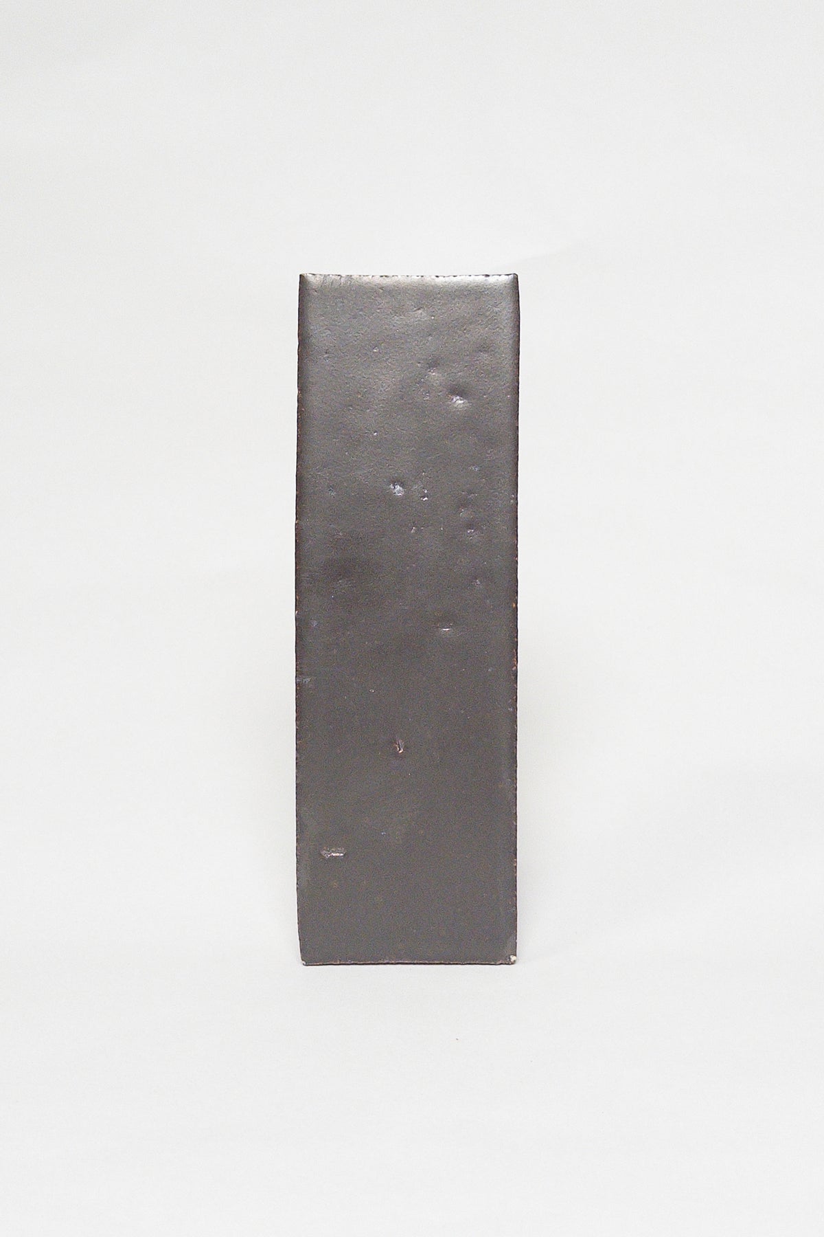 Artisan Baked smoky dark brown thin brick tile with a matte glaze and textured surface