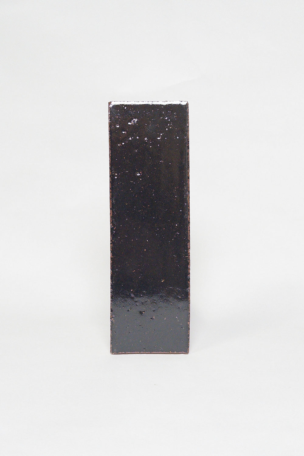 Artisan Bark near black dark brown thin brick tile with a glossy glaze and textured surface