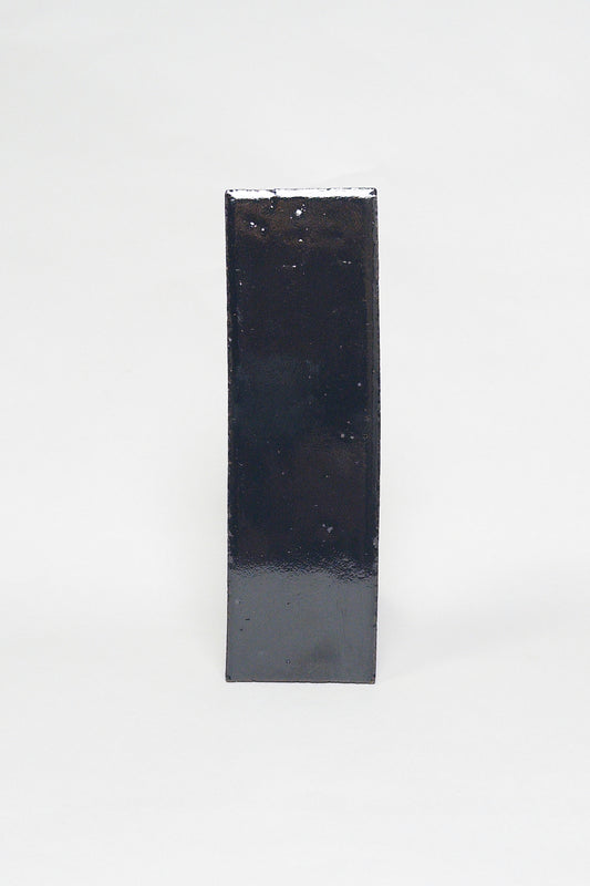 Artisan Caviar black thin brick tile with a glossy glaze and subtly uneven surface