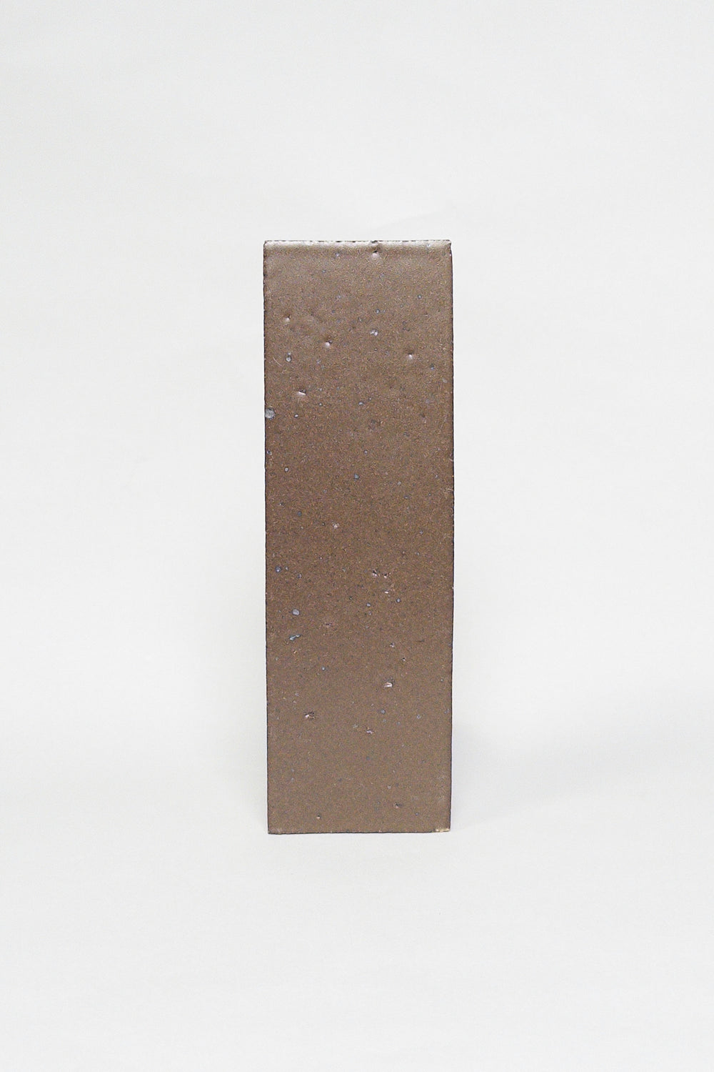 Artisan Chateau Brown warm brown thin brick tile with a matte glaze and subtle texture
