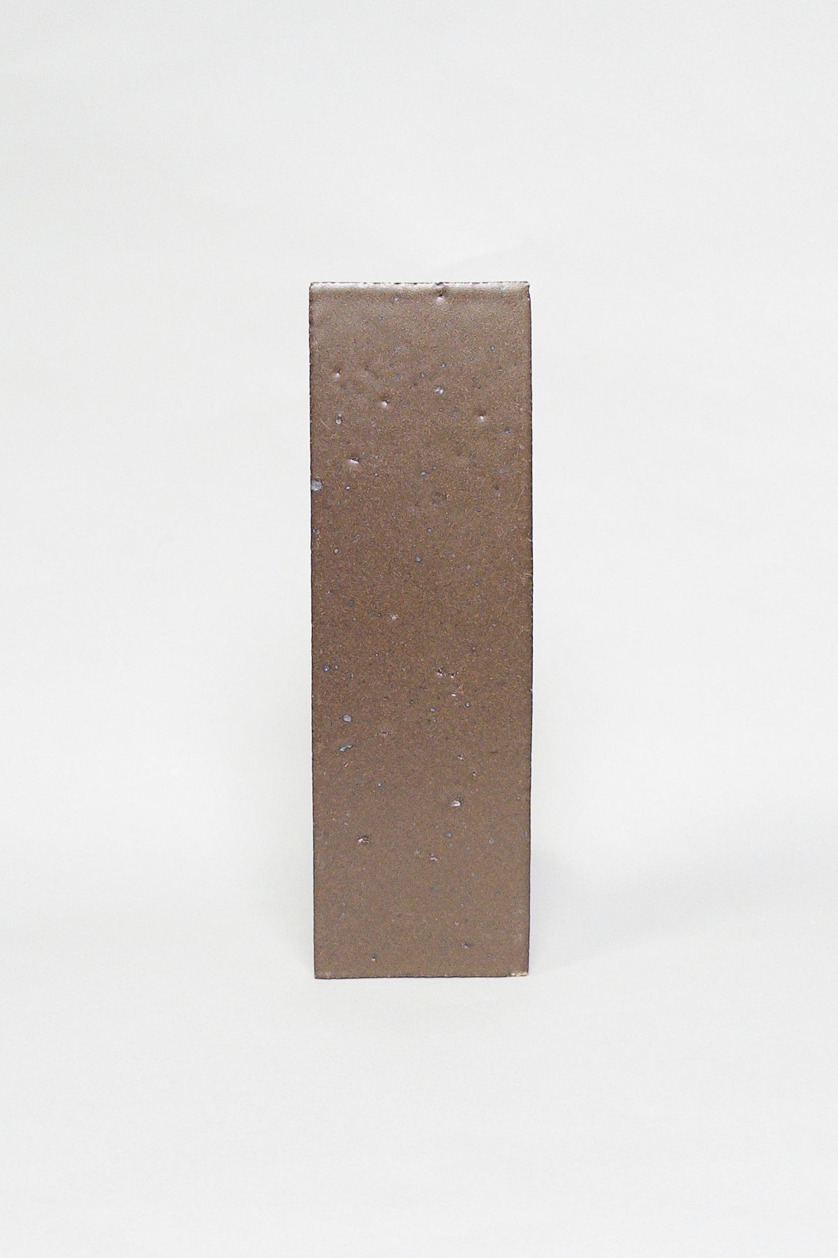 Artisan Chateau Brown warm brown thin brick tile with a matte glaze and subtle texture