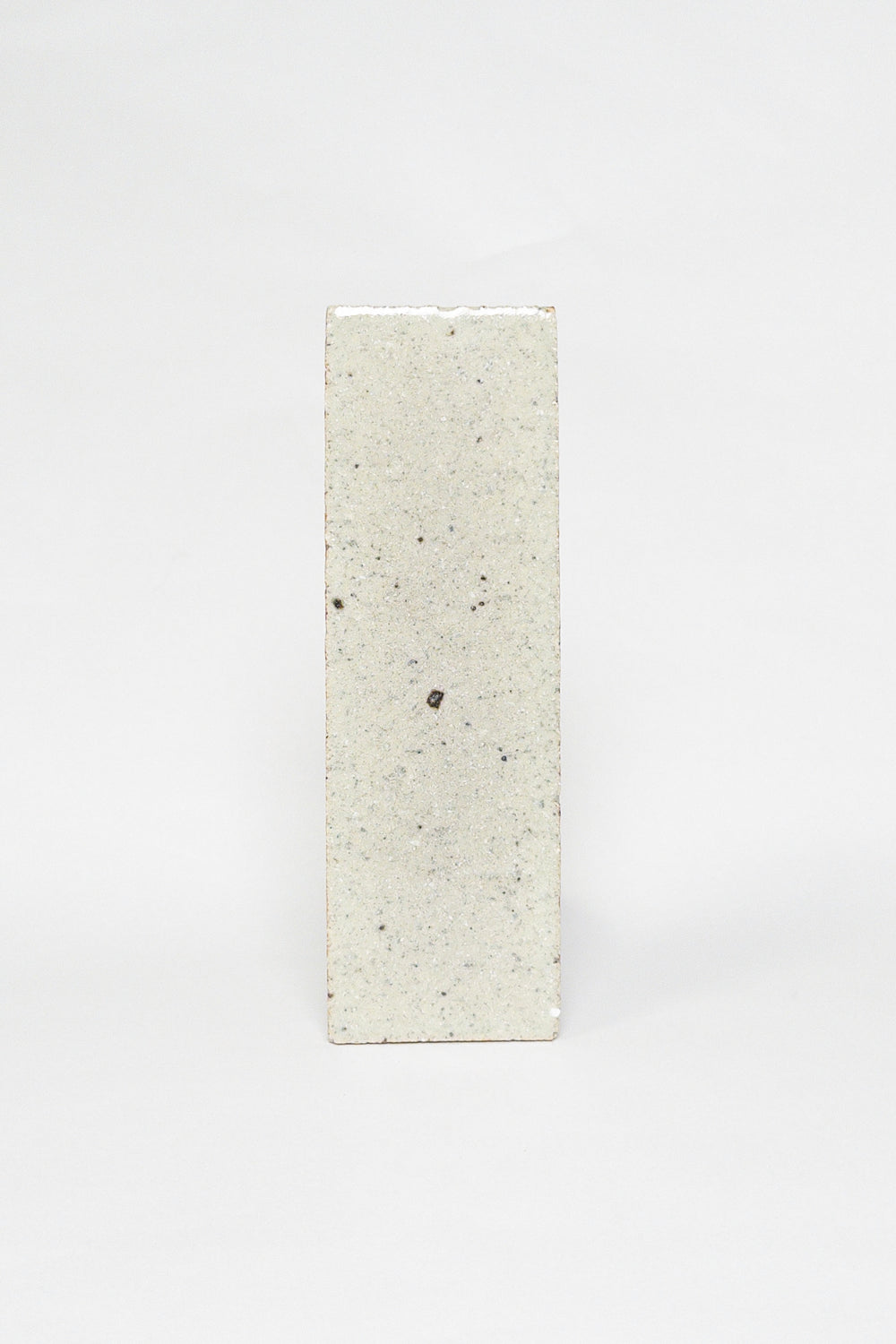 Artisan Dovetail light greige thin brick tile with a matte surface and darker speckles