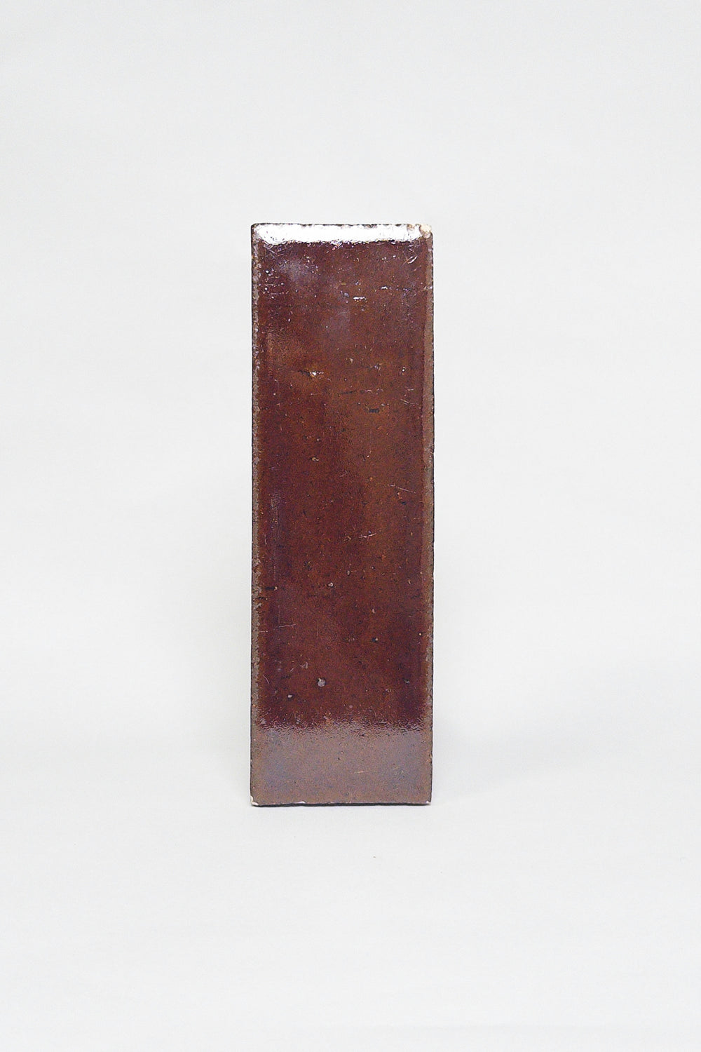 Artisan Java reddish brown thin brick tile with a glossy glaze and rich tonal variation