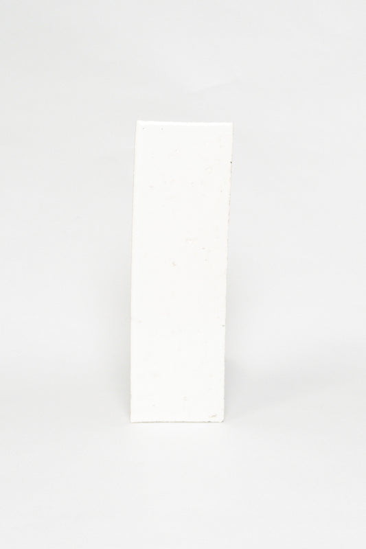 Artisan Oat Milk white thin brick tile with a glossy glaze and textured edges