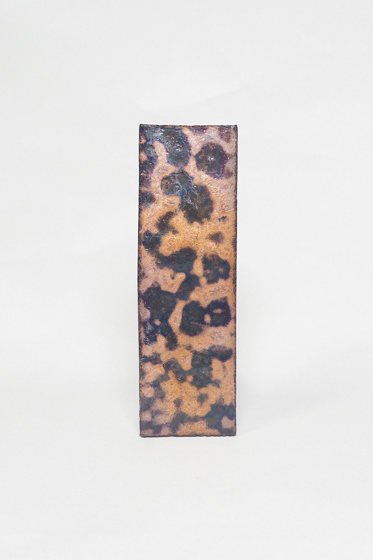 Artisan Oxide thin brick tile with a matte glaze and bold ochre rust and charcoal mottling