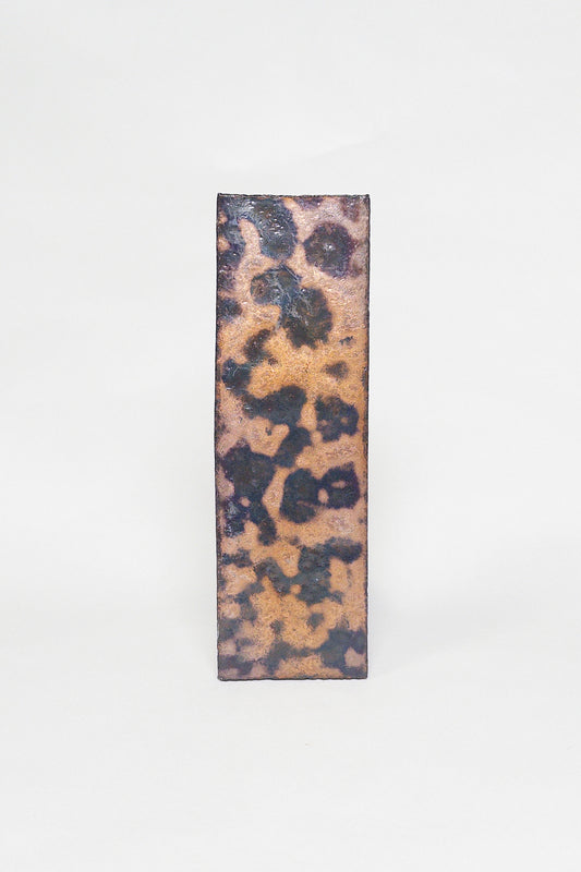 Artisan Oxide thin brick tile with a matte glaze and bold ochre rust and charcoal mottling