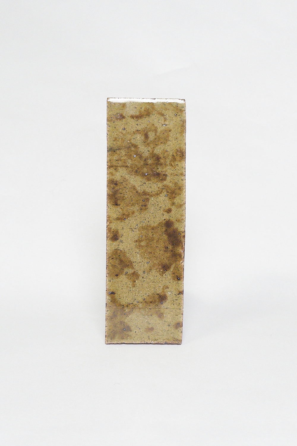 Artisan Seagrass thin brick tile with a glossy glaze and mottled olive ochre and brown tones