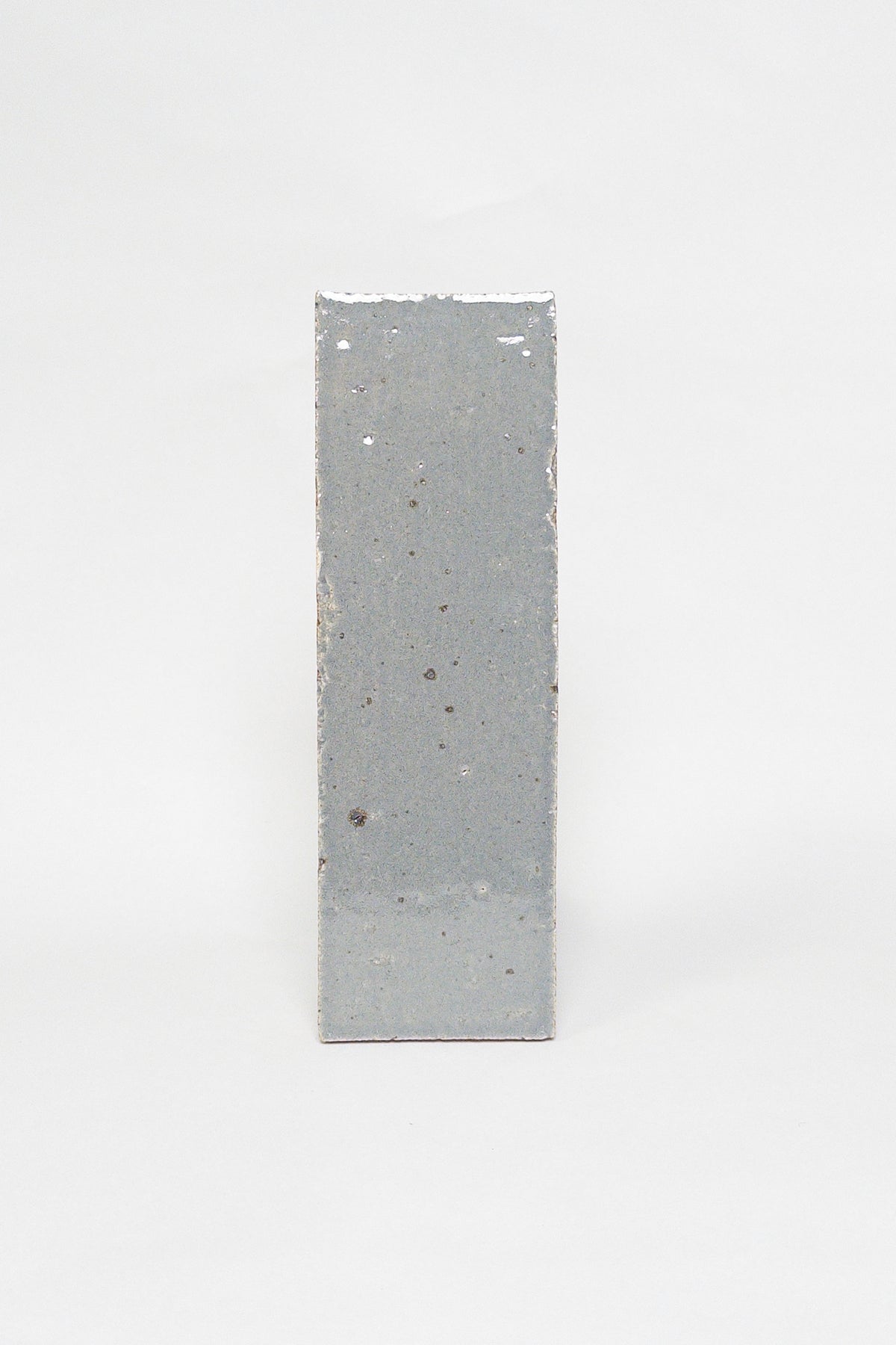 Artisan Smoke grey thin brick tile with a glossy glaze and softly varied surface