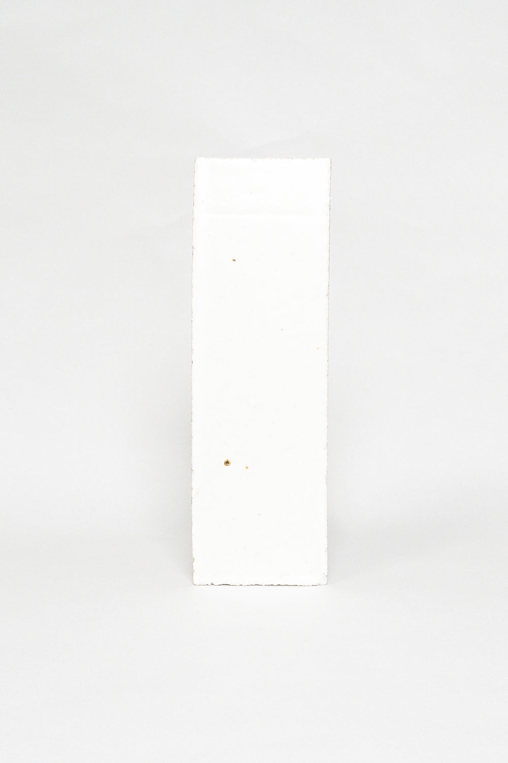Artisan Snowfall white thin brick tile with a matte glaze and subtle surface texture