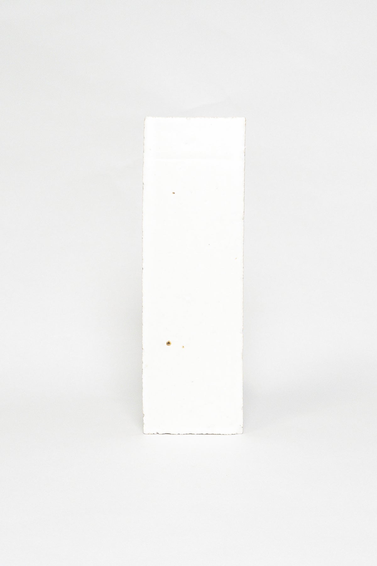 Artisan Snowfall white thin brick tile with a matte glaze and subtle surface texture