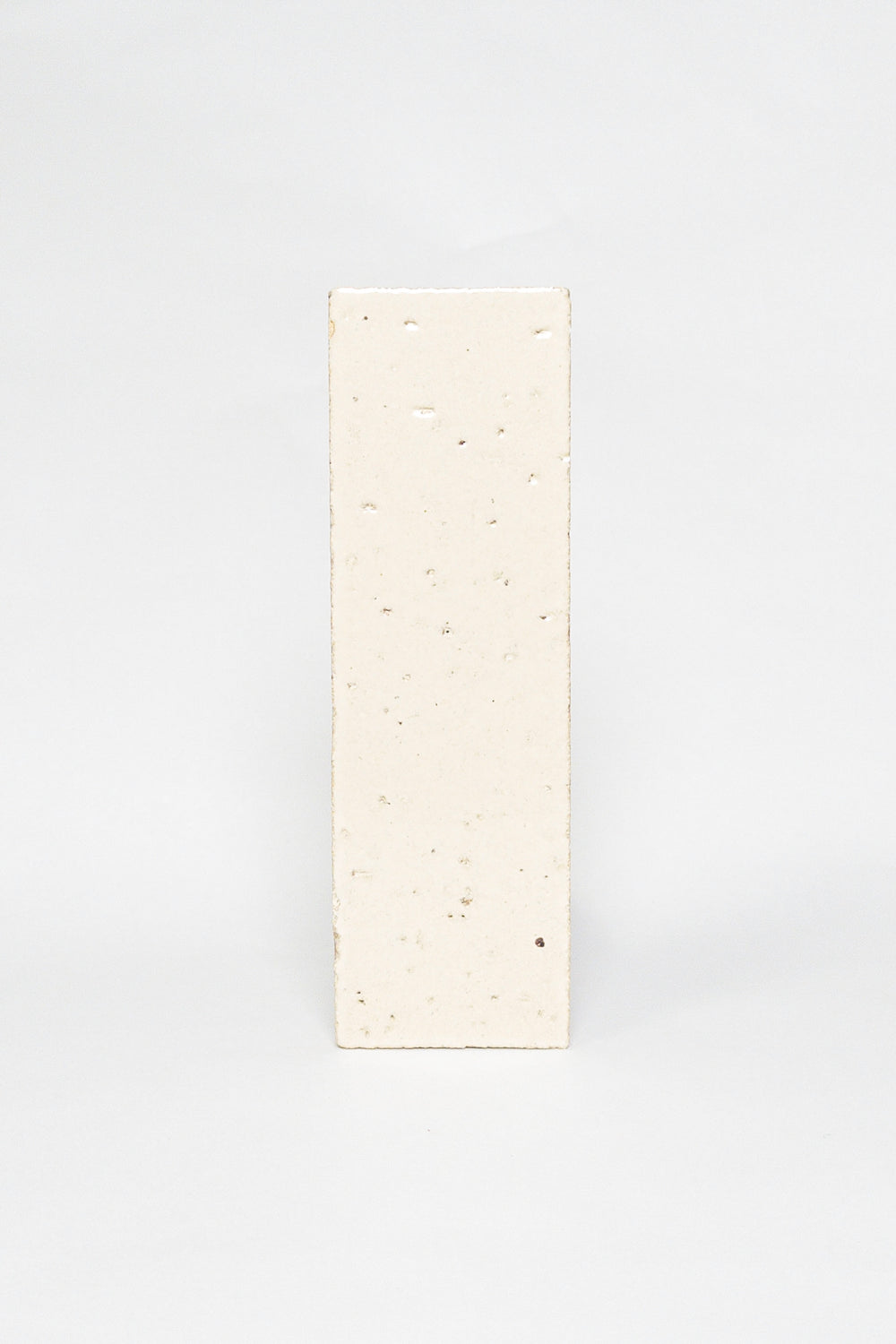 Artisan Sunkissed cream thin brick tile with a glossy glaze and fine speckles