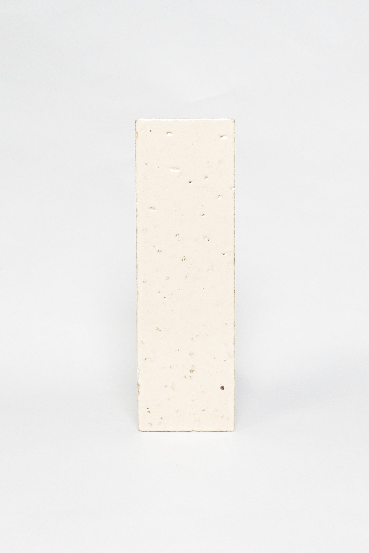 Artisan Sunkissed cream thin brick tile with a glossy glaze and fine speckles