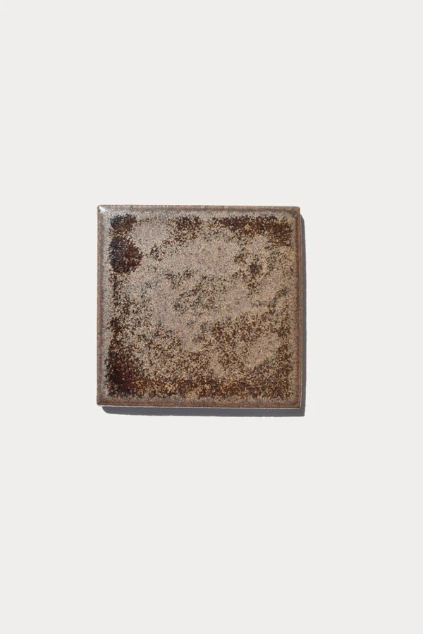 Ember BURNISH Piedras 88 tile sample on off-white background