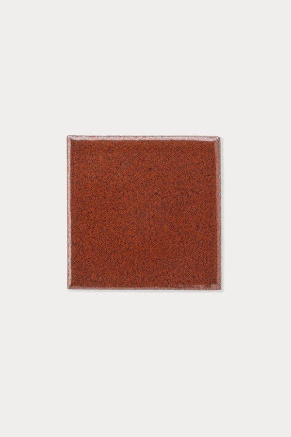 Summit ZION Iron Red Gloss tile sample on off-white background